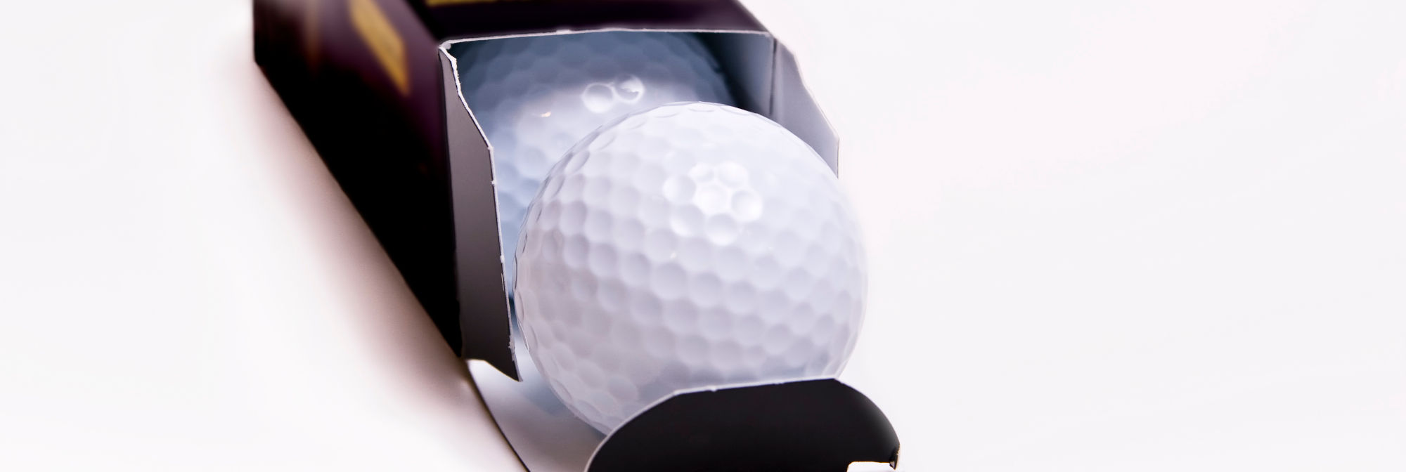 Box of new premium golf balls.